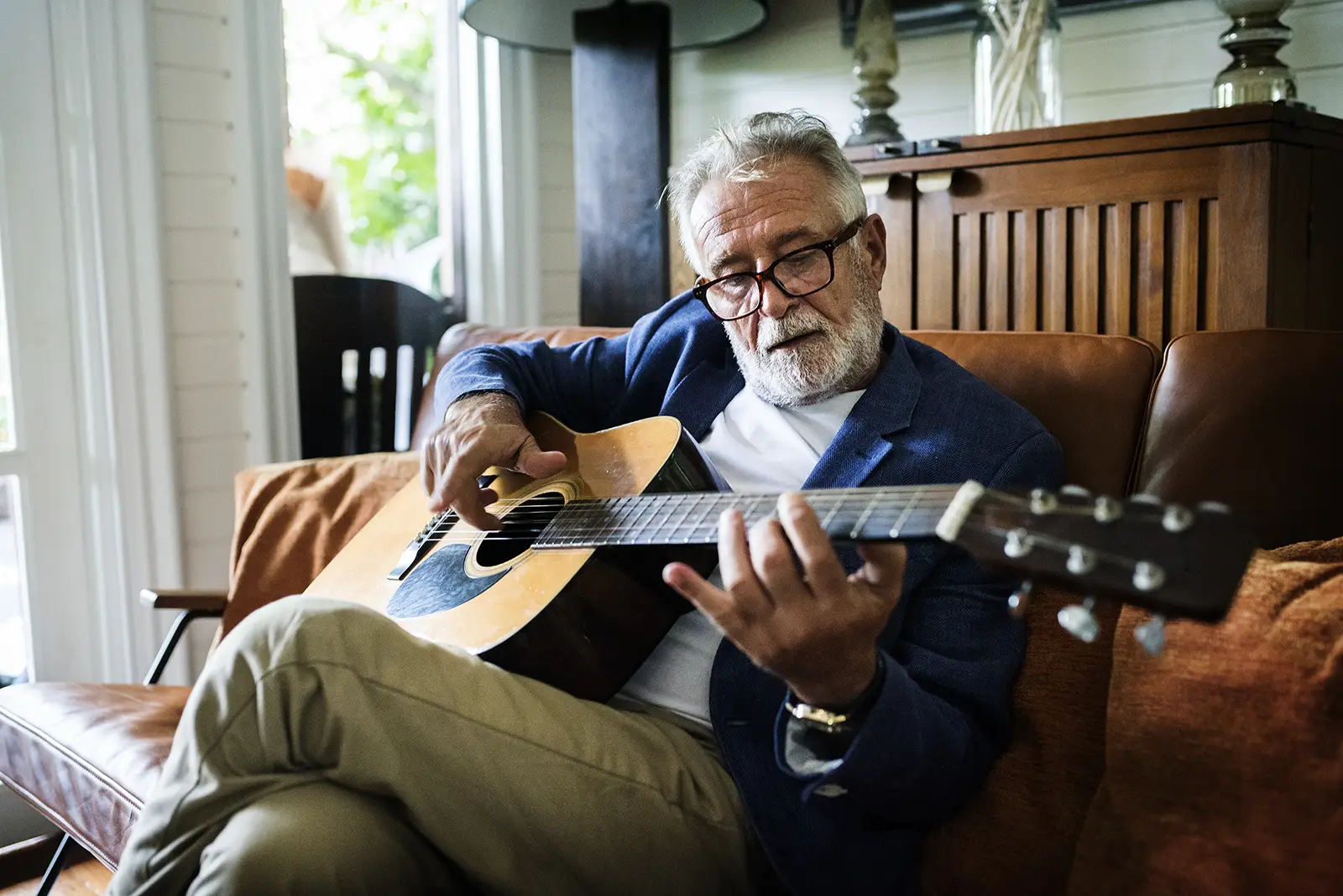 Elderly gentleman playing the guitar