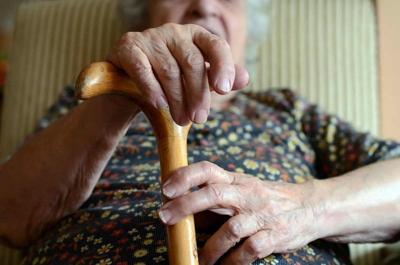 An elderly woman with a cane