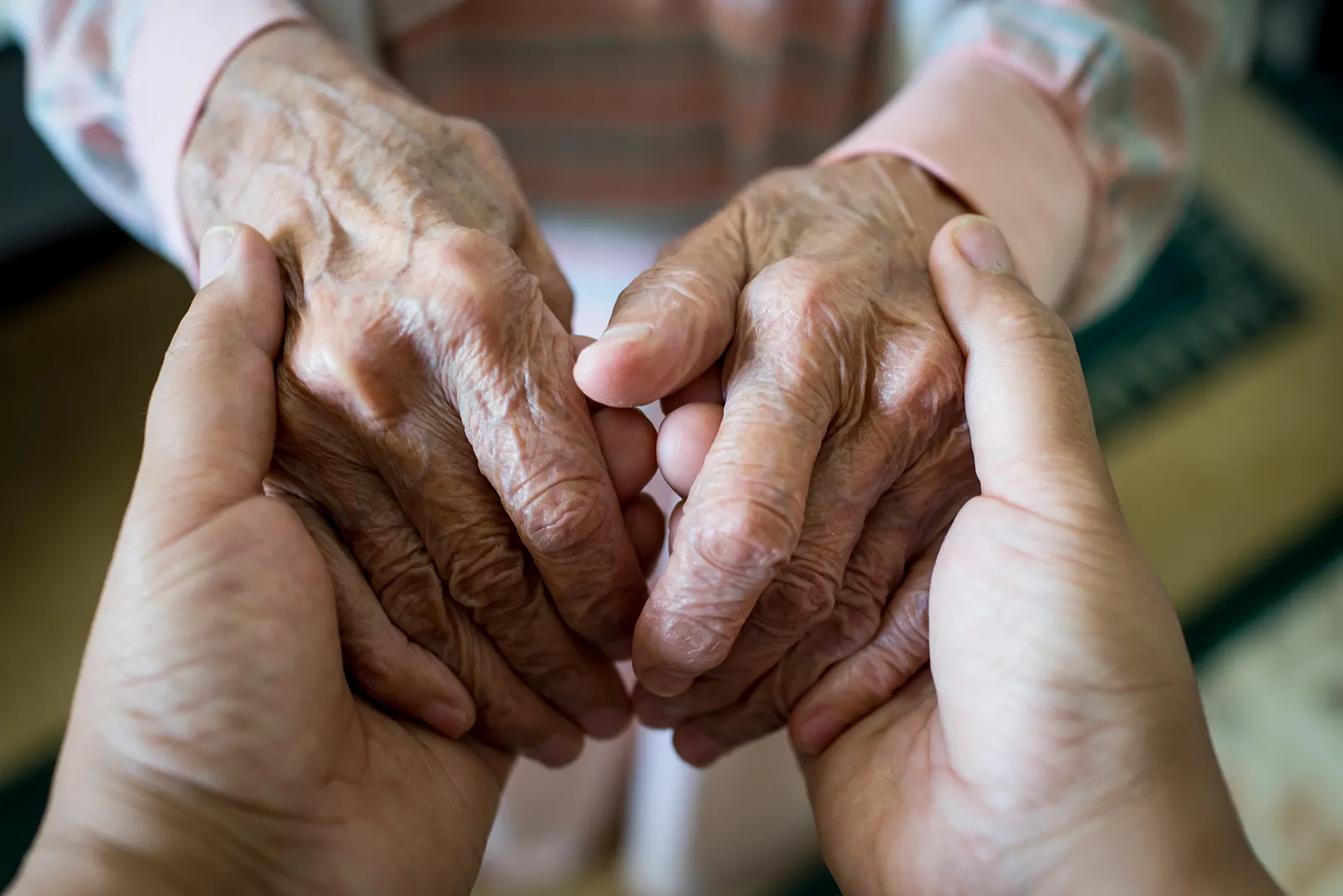 Holding an elderly person's hands